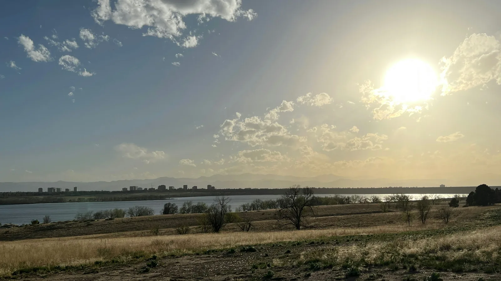 Sun over Cherry Creek Reservoir and open prairie near Centennial, Colorado